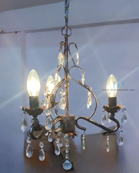 Antique Gold 3 Light Mid-century Modern Handcrafted Metal Mini Chandelier With Crystals, Candelabra Base Type And Floral Details, available exclusively on Shahi Sajawat India, the world of home decor products.Best trendy home decor, living room, kitchen and bathroom decor ideas of 2024.